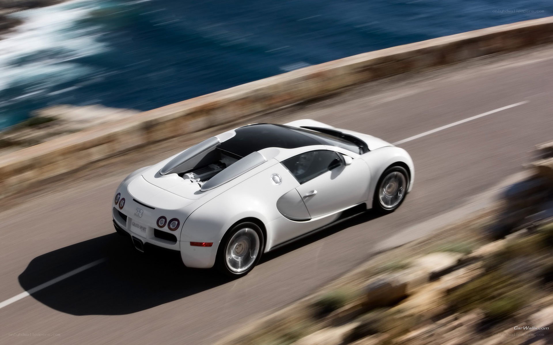 White Bugatti speeding on coastal road