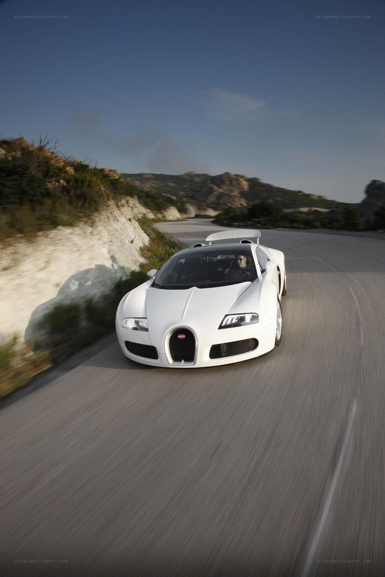 White Bugatti Veyron on a winding road