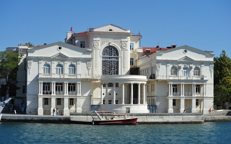 White Building by Water — Serene