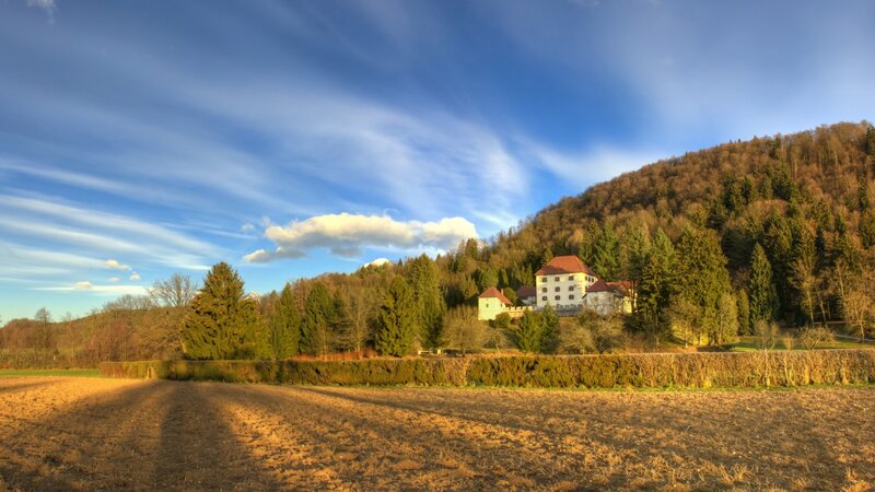 White Building on Hillside — Blue