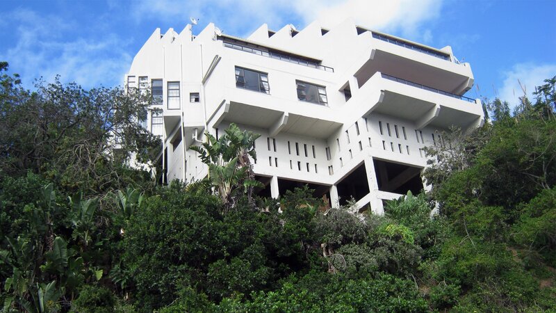 White Building on Hillside — Serene
