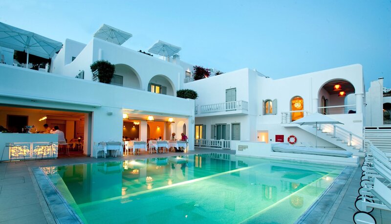 White building with pool at dusk