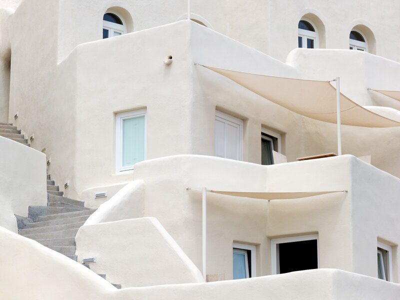 White building with stairs and awnings