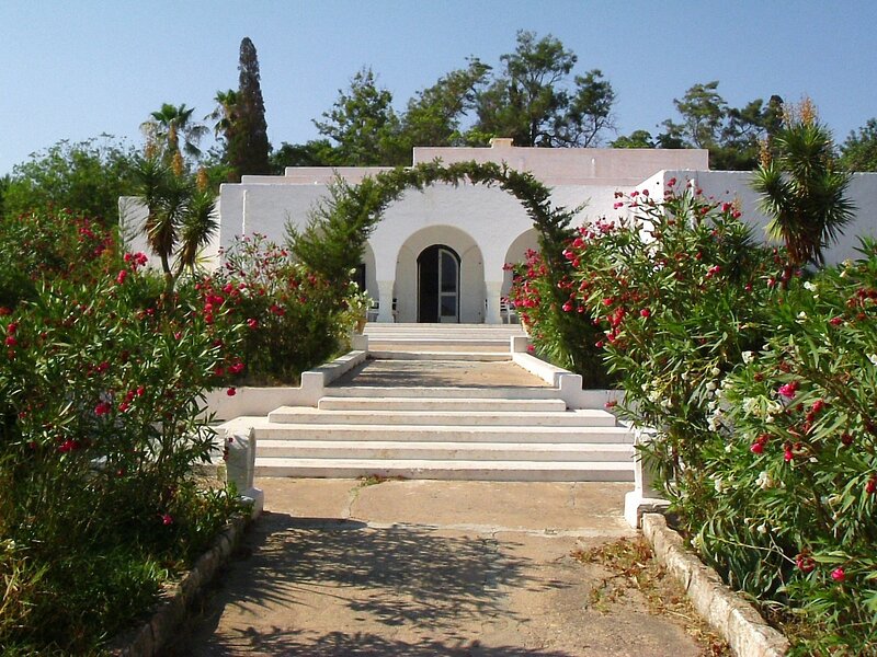 white building with steps and flowers