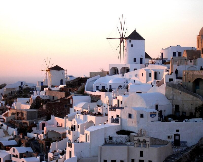 White buildings and windmills at sunset