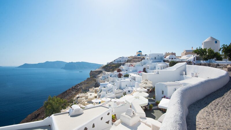 White Buildings on Cliff — Serene, Afternoon, Photograph, Sea, Mountain