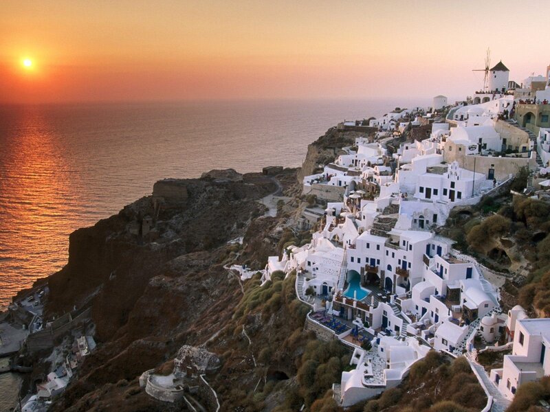 White Buildings on Cliff — Serene, Sunset, Photograph, Sea, Windmill, Orange, Blue