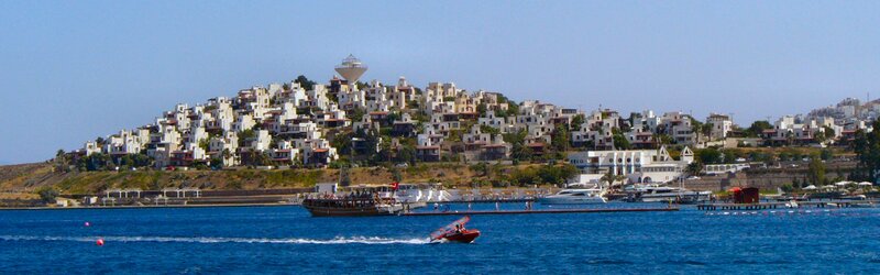 White Buildings on Hillside — Blue, Serene, Afternoon