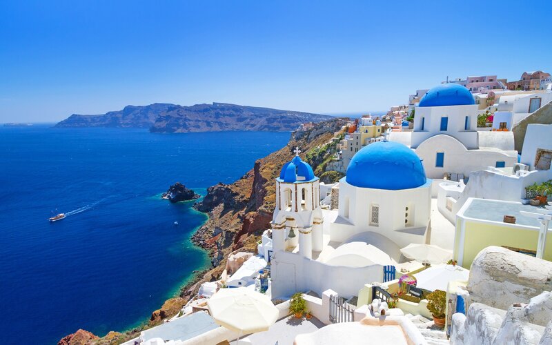 White Buildings with Blue Domes — Serene, Afternoon, Photograph, Ocean