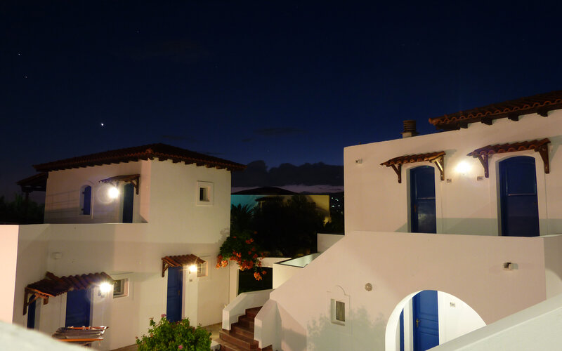 White buildings with blue doors at night