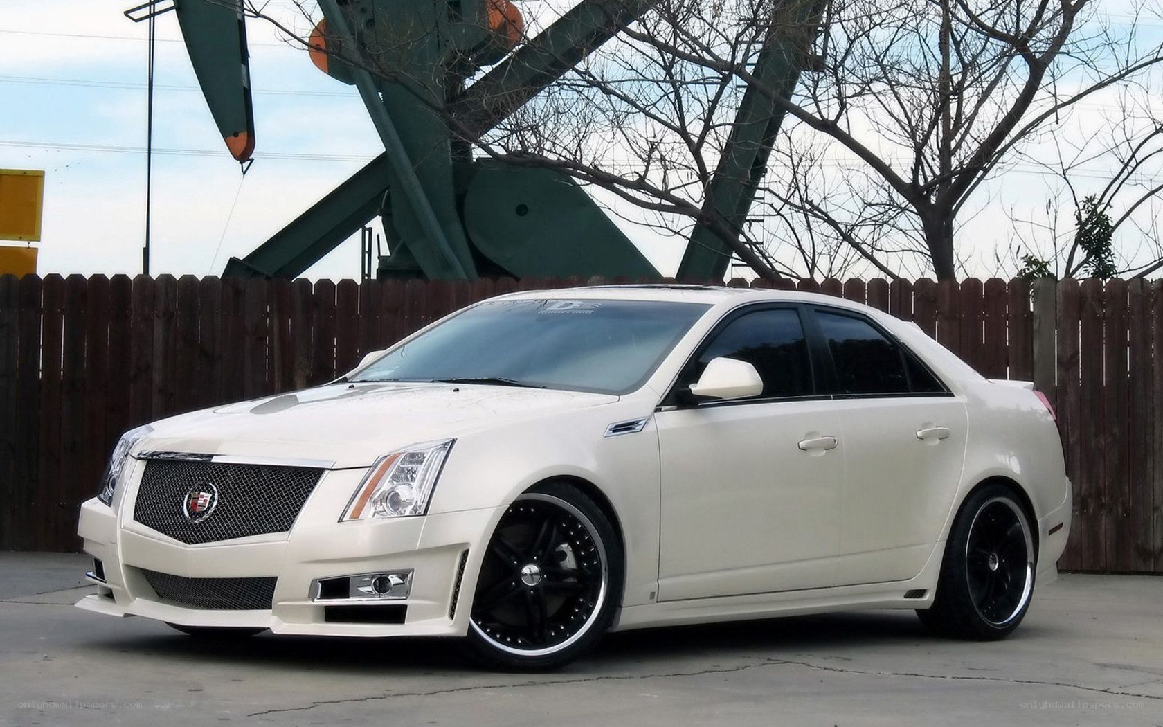 white cadillac sedan with custom wheels