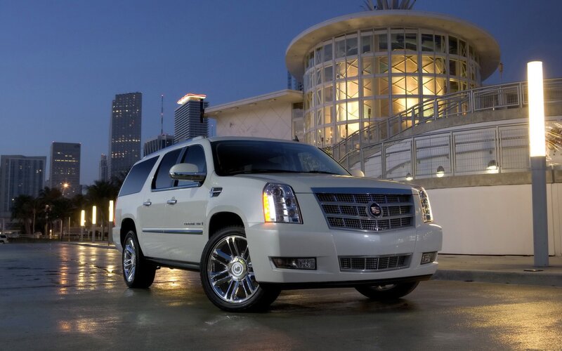 White Cadillac SUV at dusk