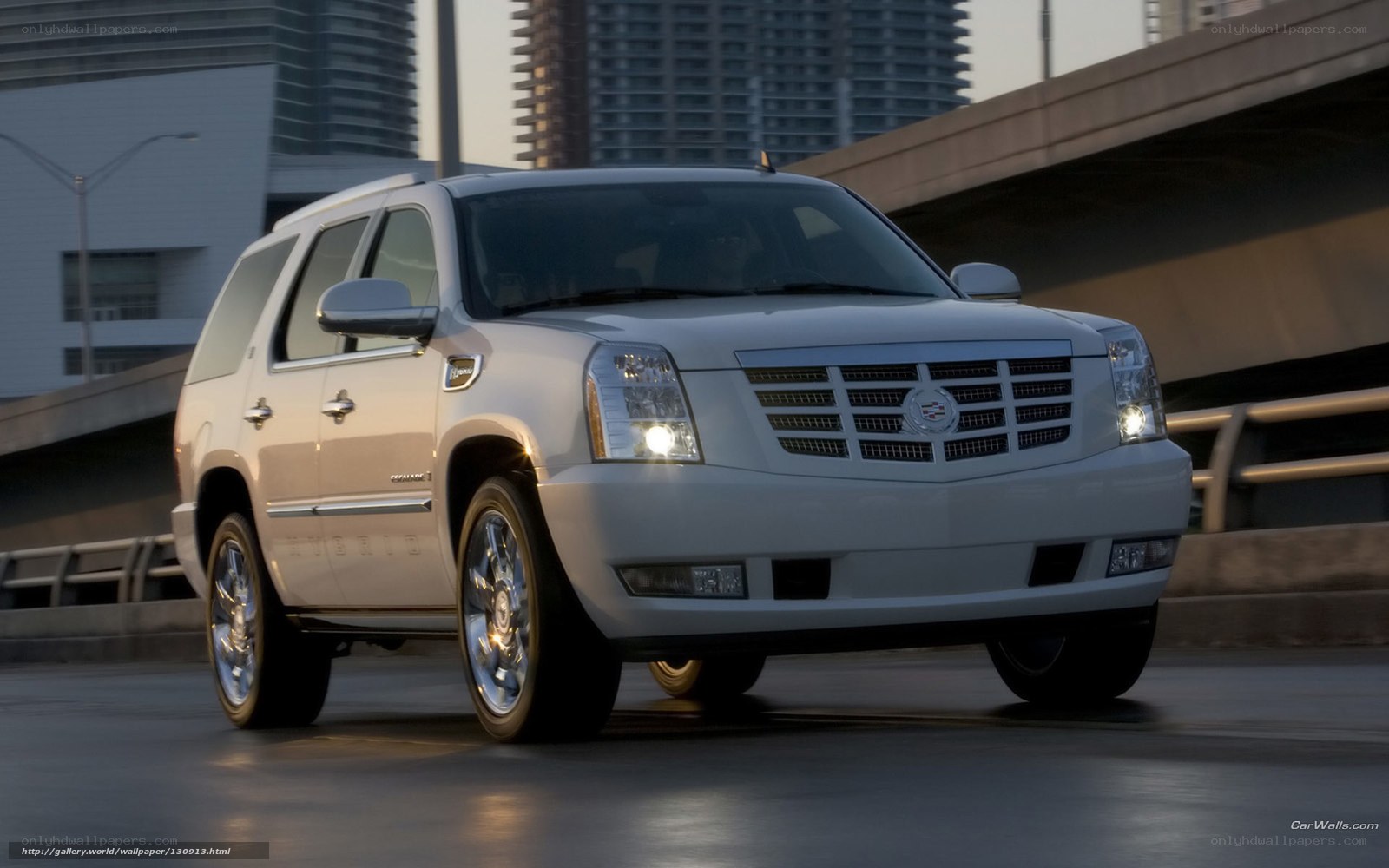White Cadillac SUV on city bridge