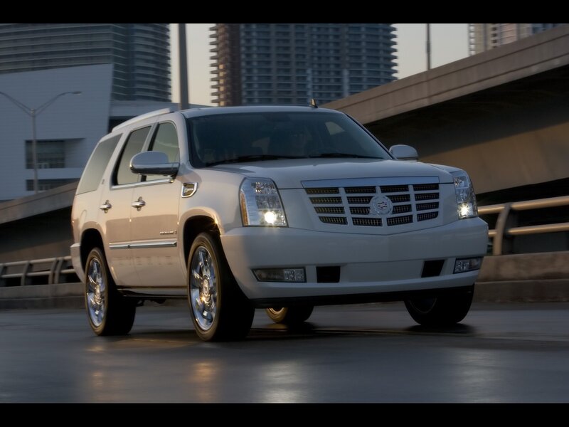 White Cadillac SUV on city road