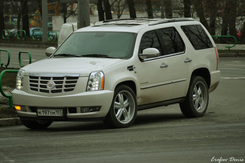white cadillac suv on street