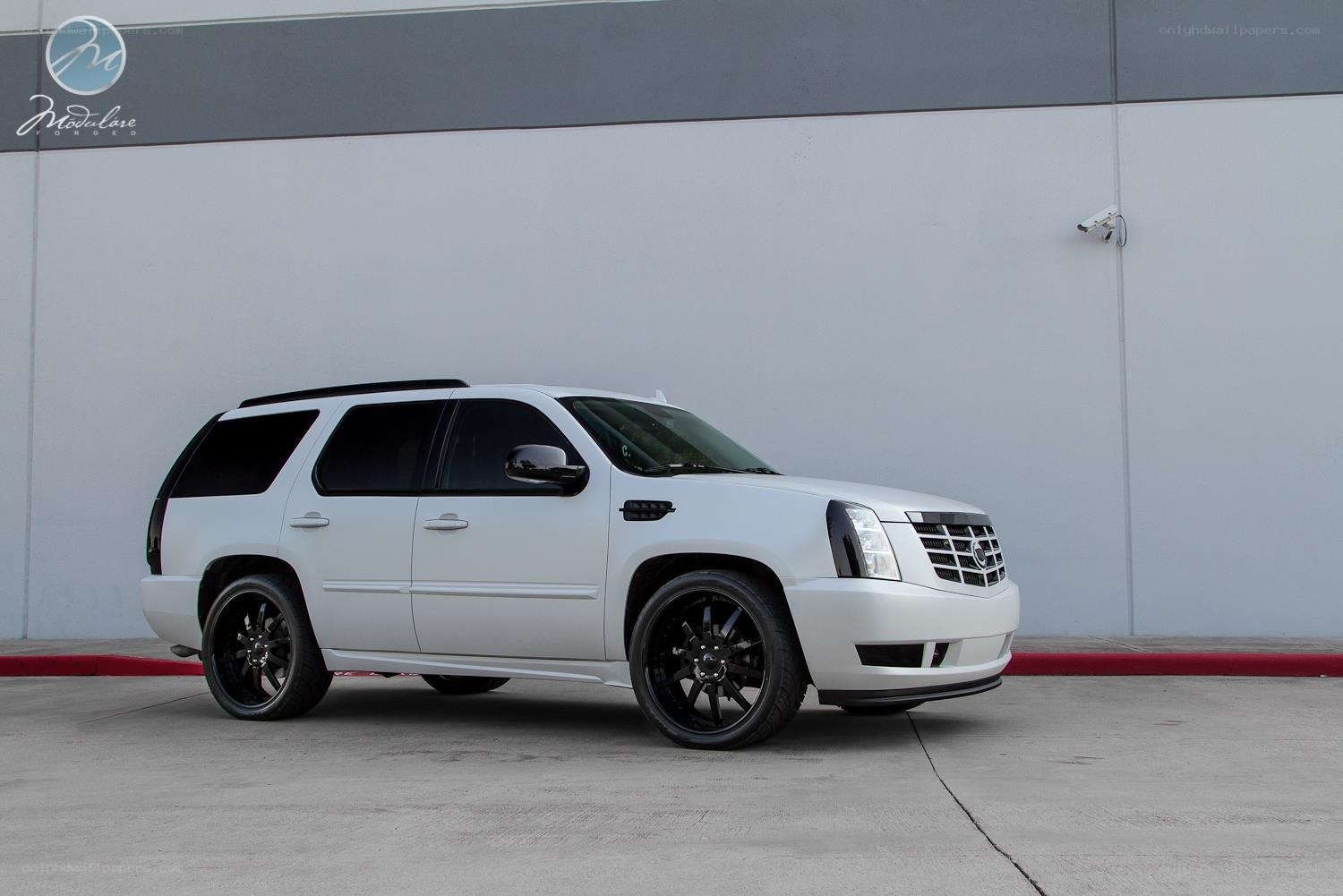 white cadillac suv with black wheels