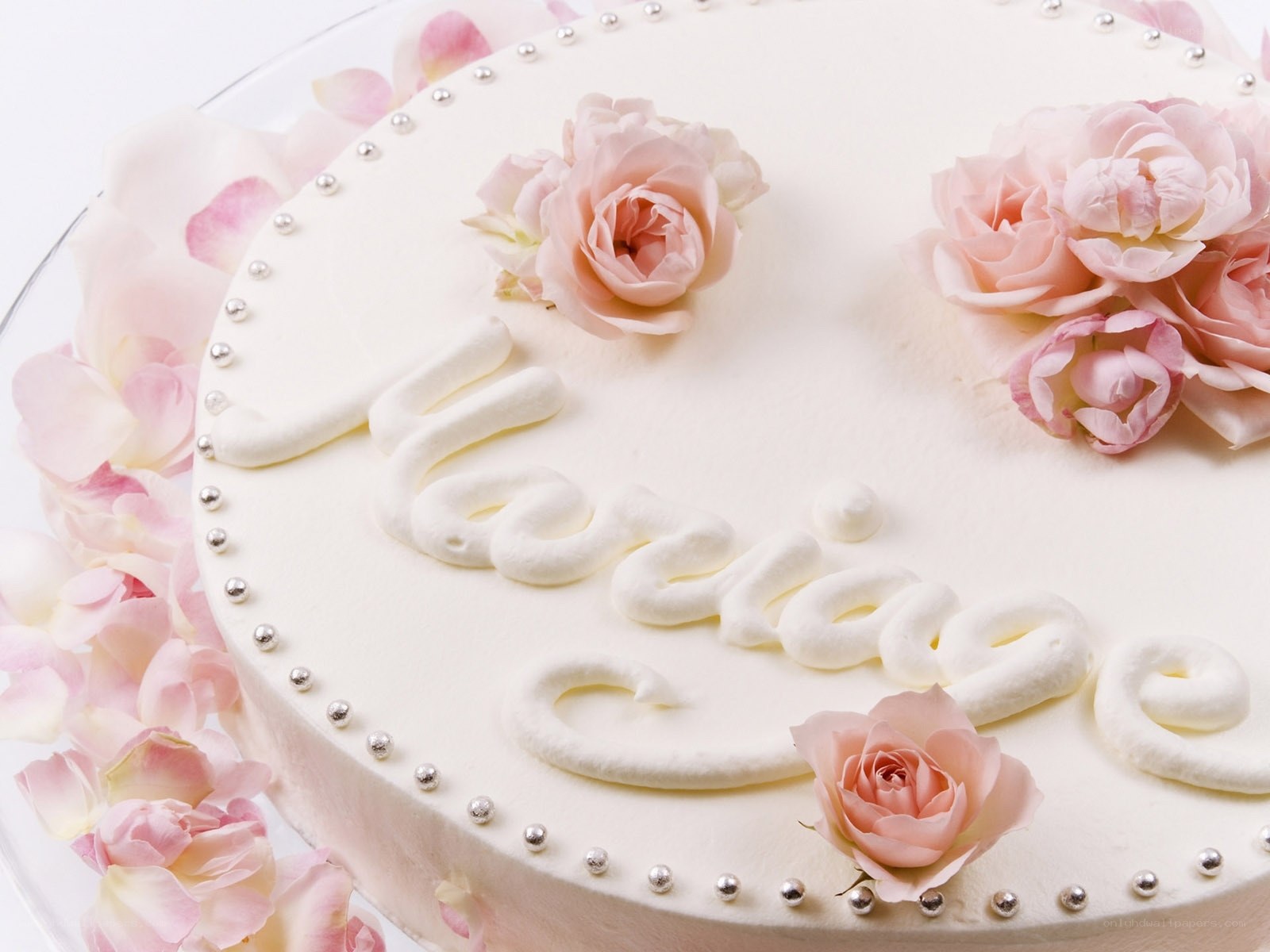 white cake with pink roses