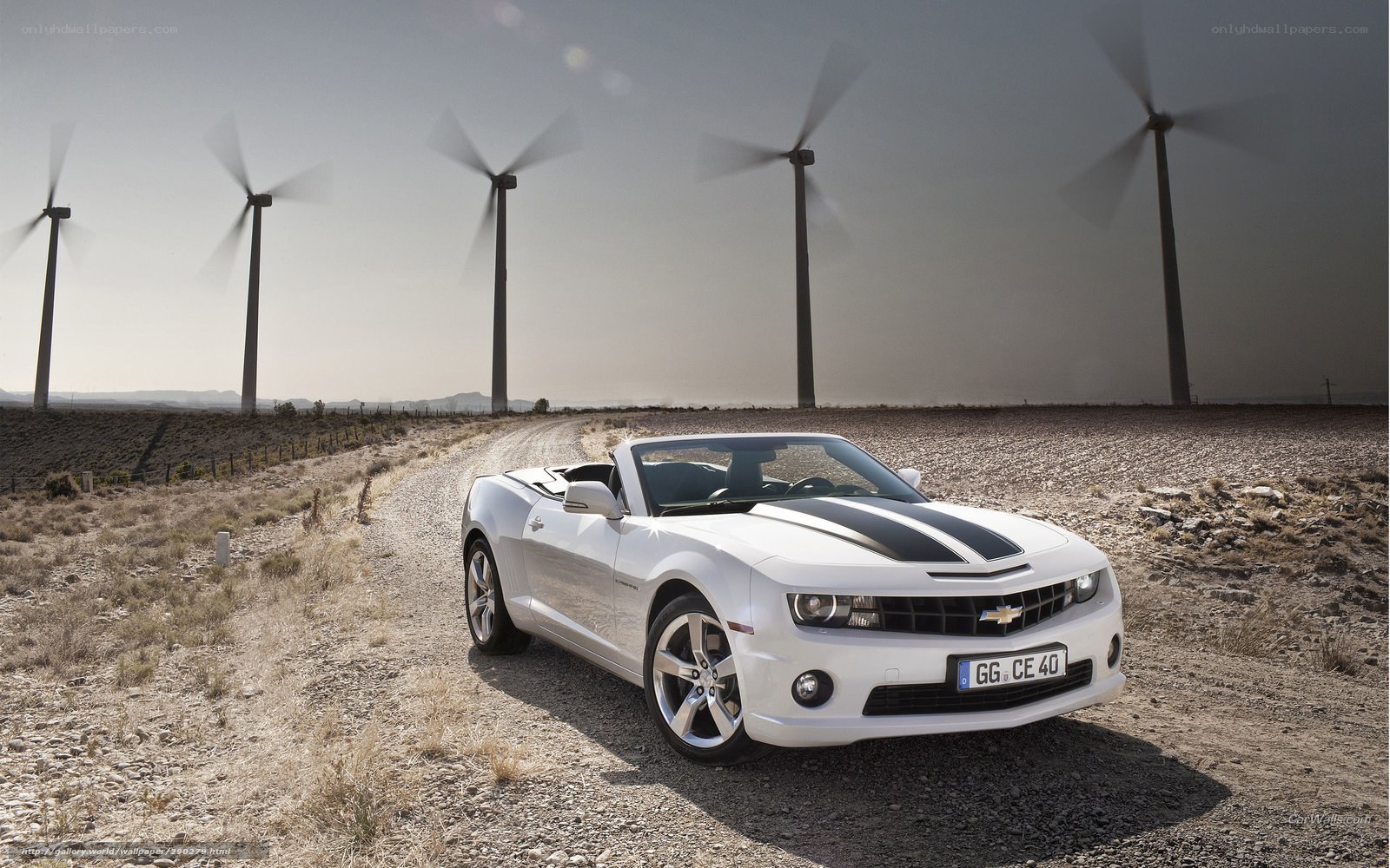 White Camaro convertible on dirt road