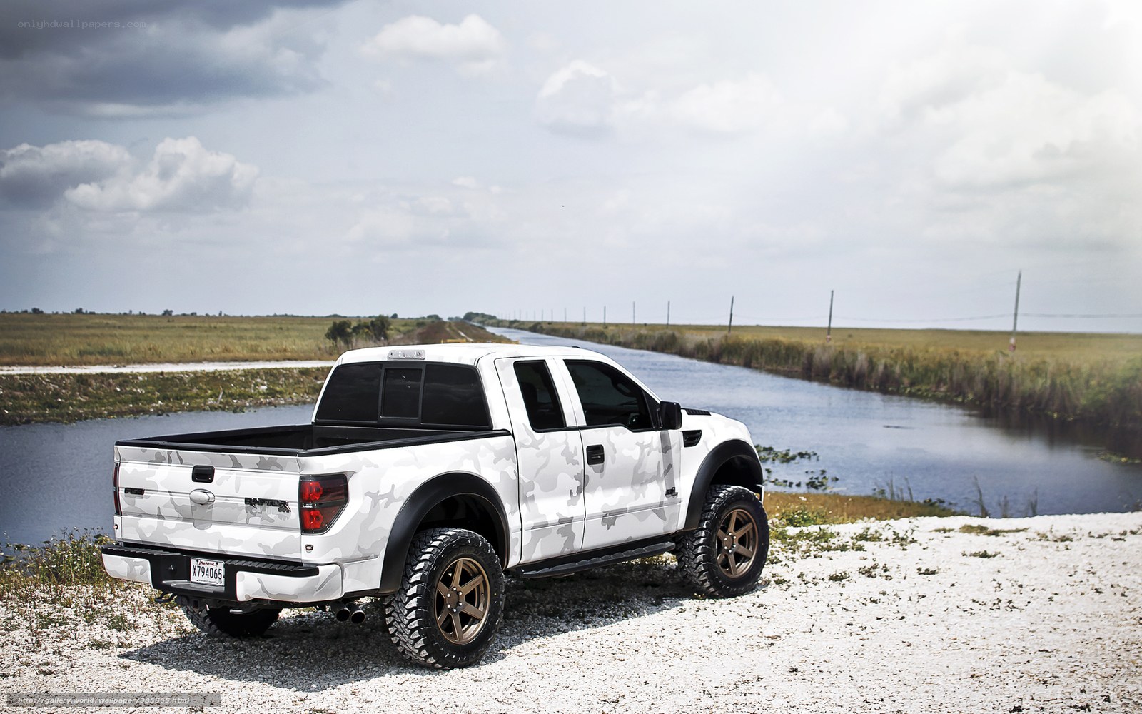 white camo truck by canal
