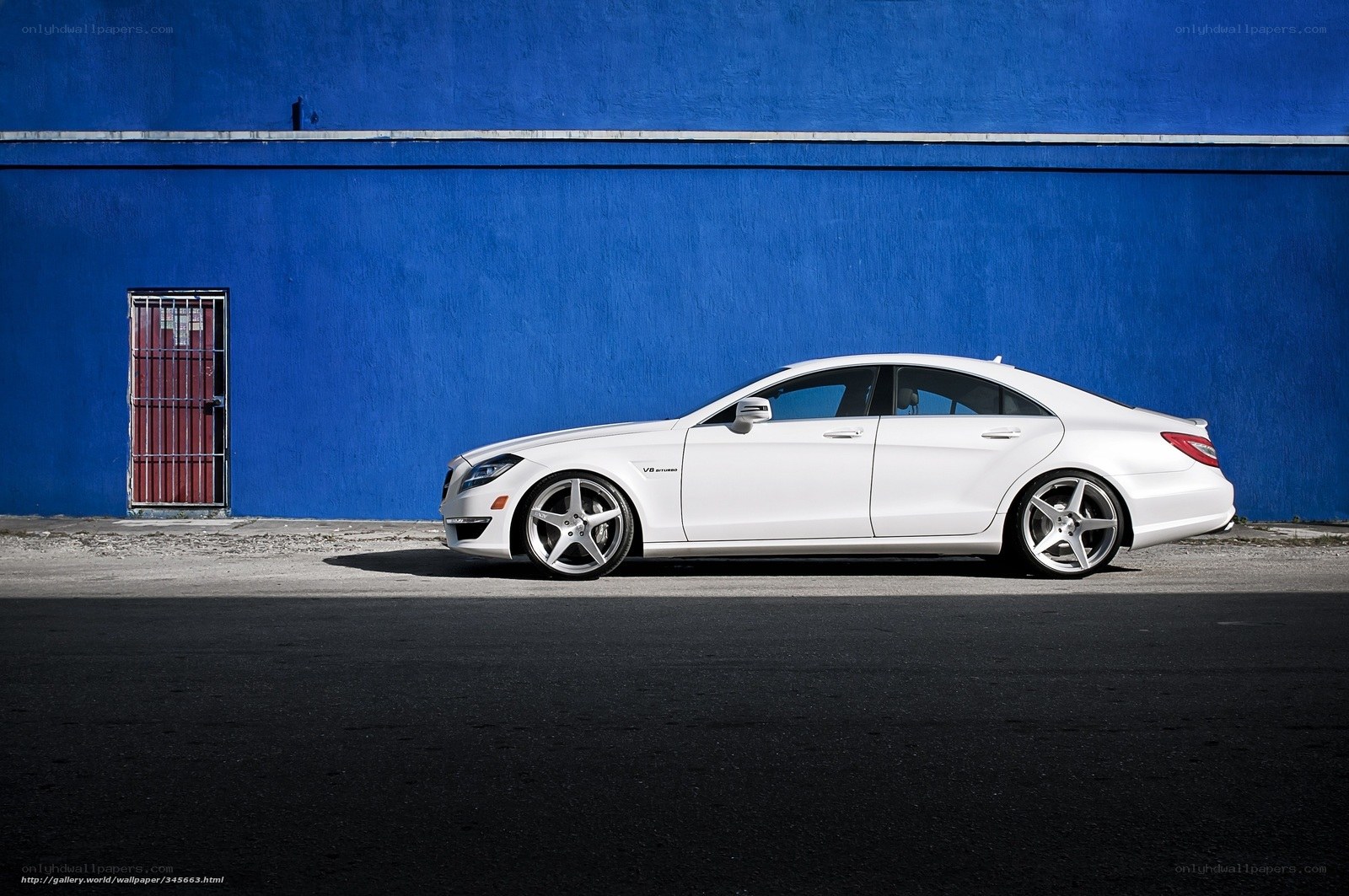 White car against blue wall