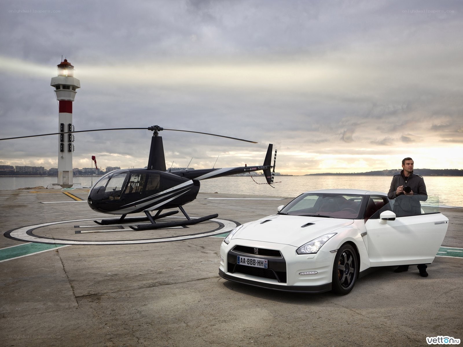 White car and helicopter at dock