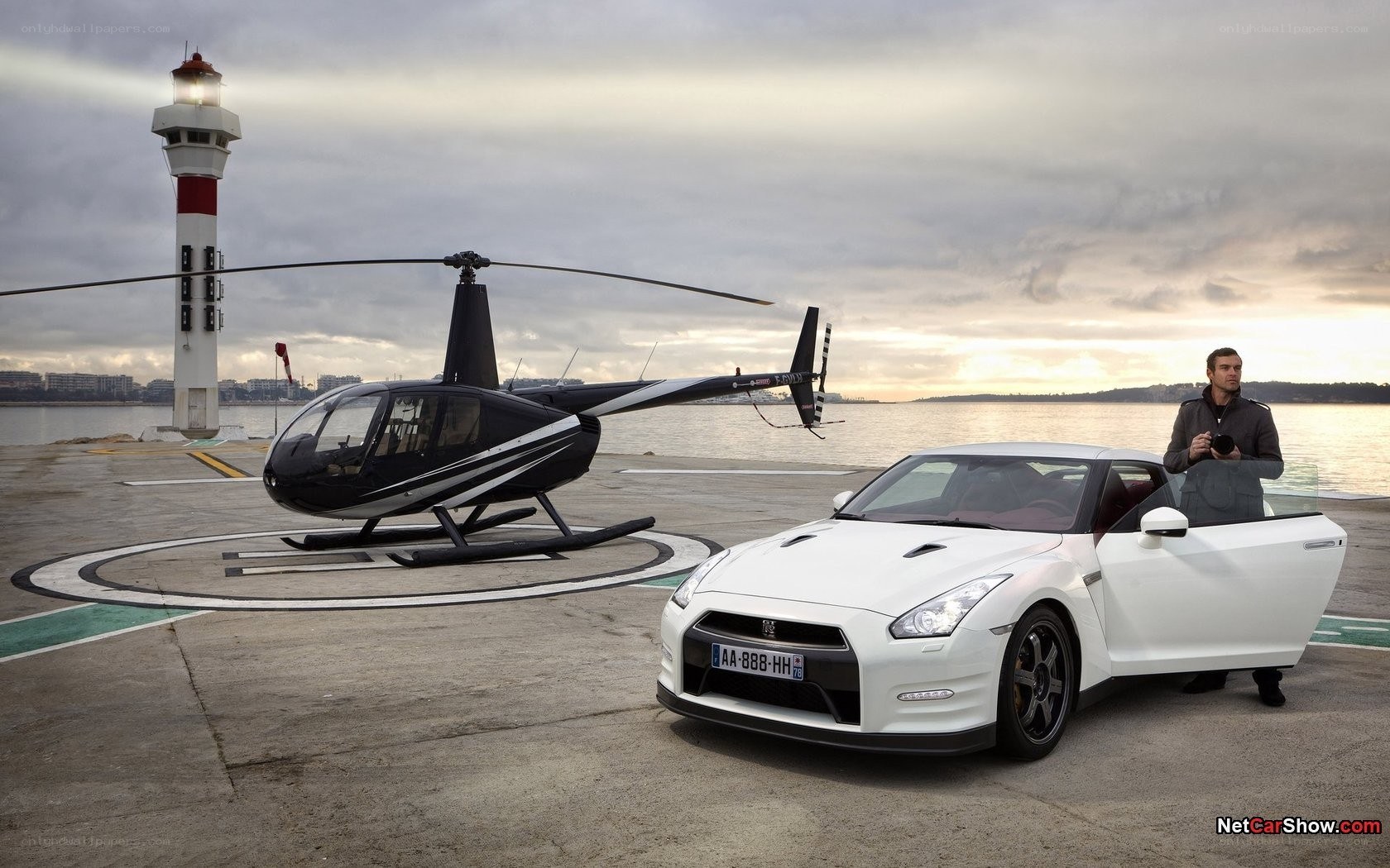 White car and helicopter at dock
