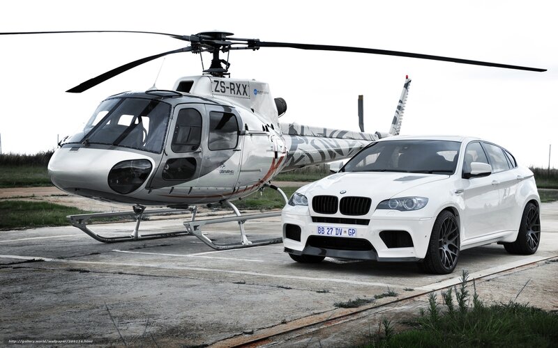 White car and helicopter on tarmac