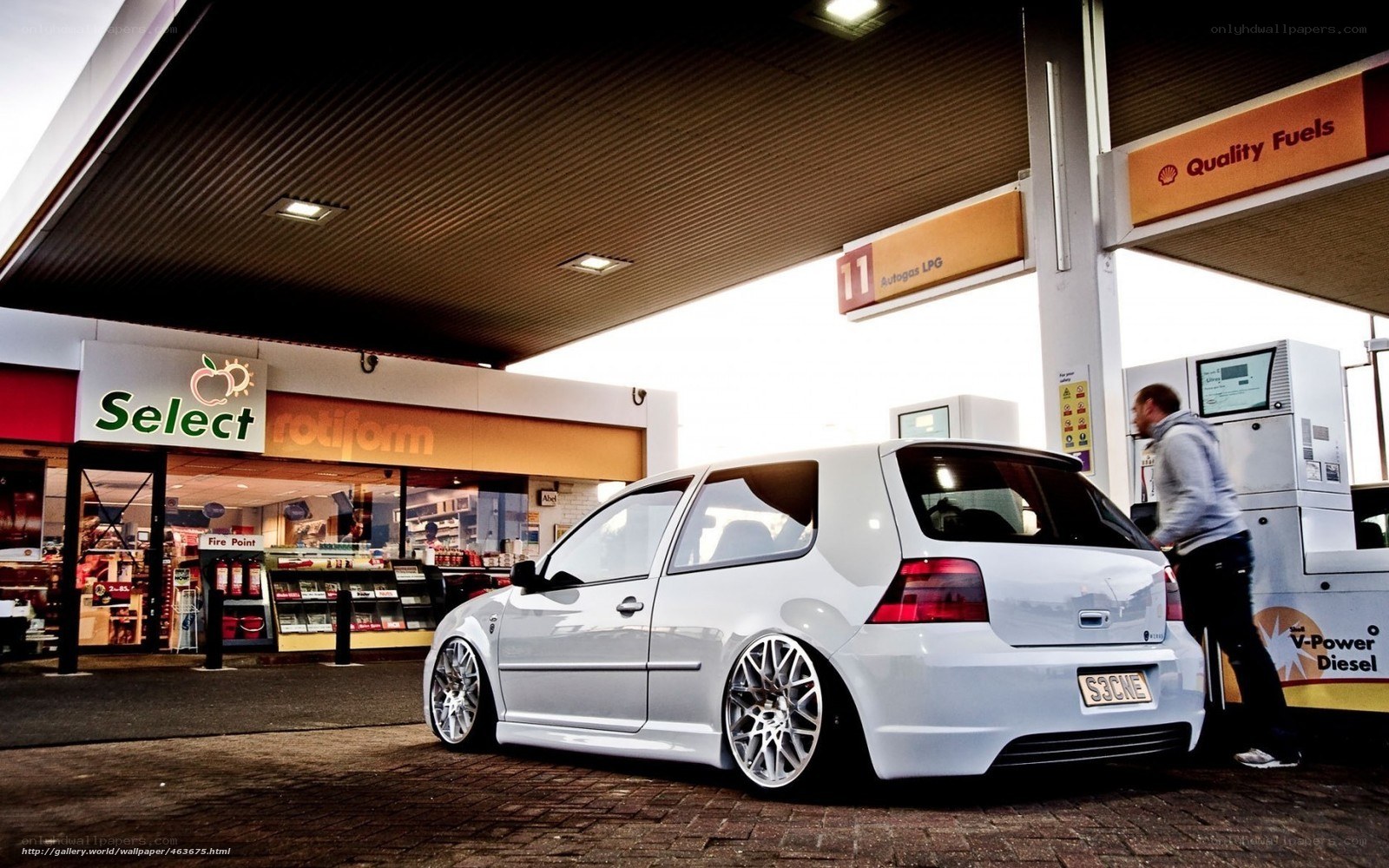 White car at gas station