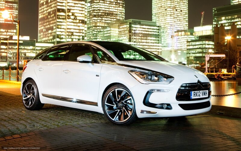 White car at night in city