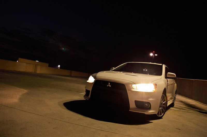 white car at night in parking garage