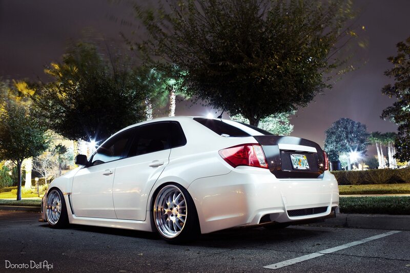 white car at night in parking lot