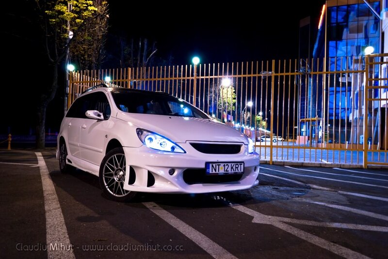 White car at night in parking lot