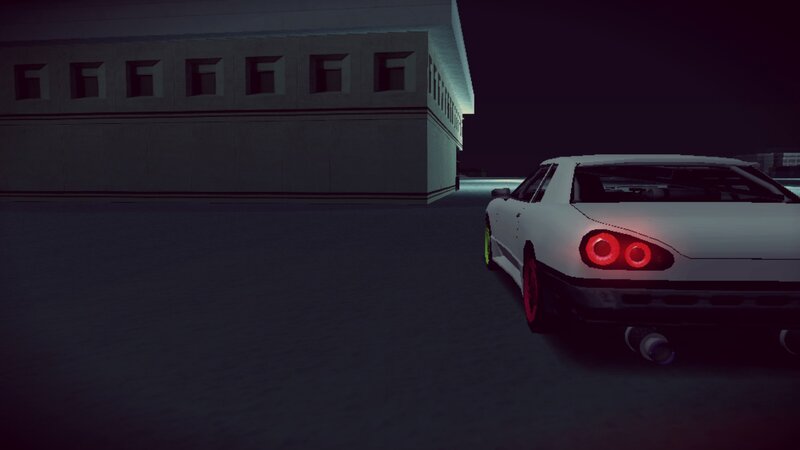 white car at night near building