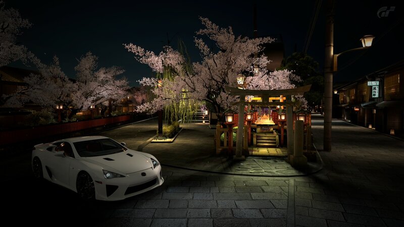 White car at night near shrine