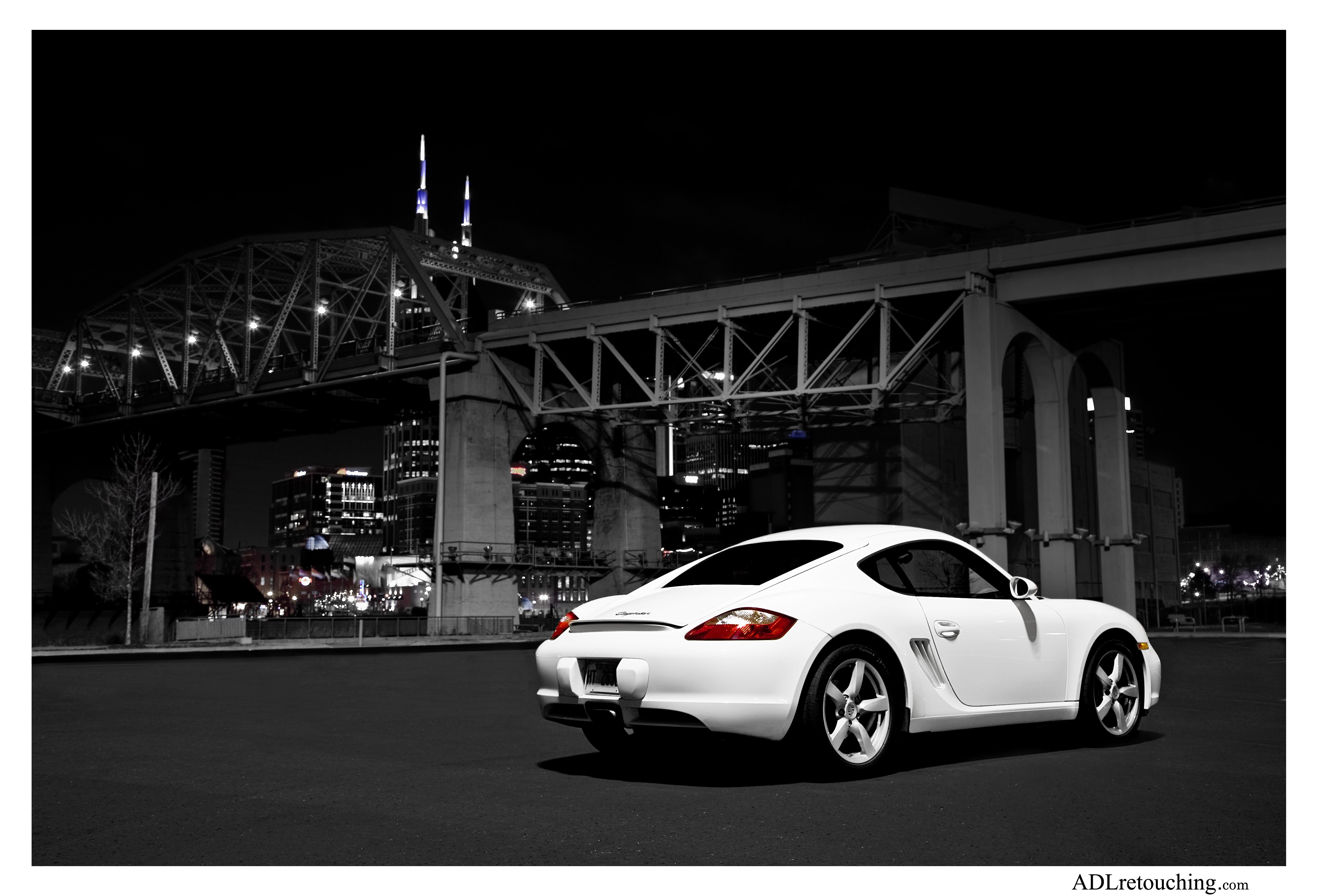 White car at night under bridge