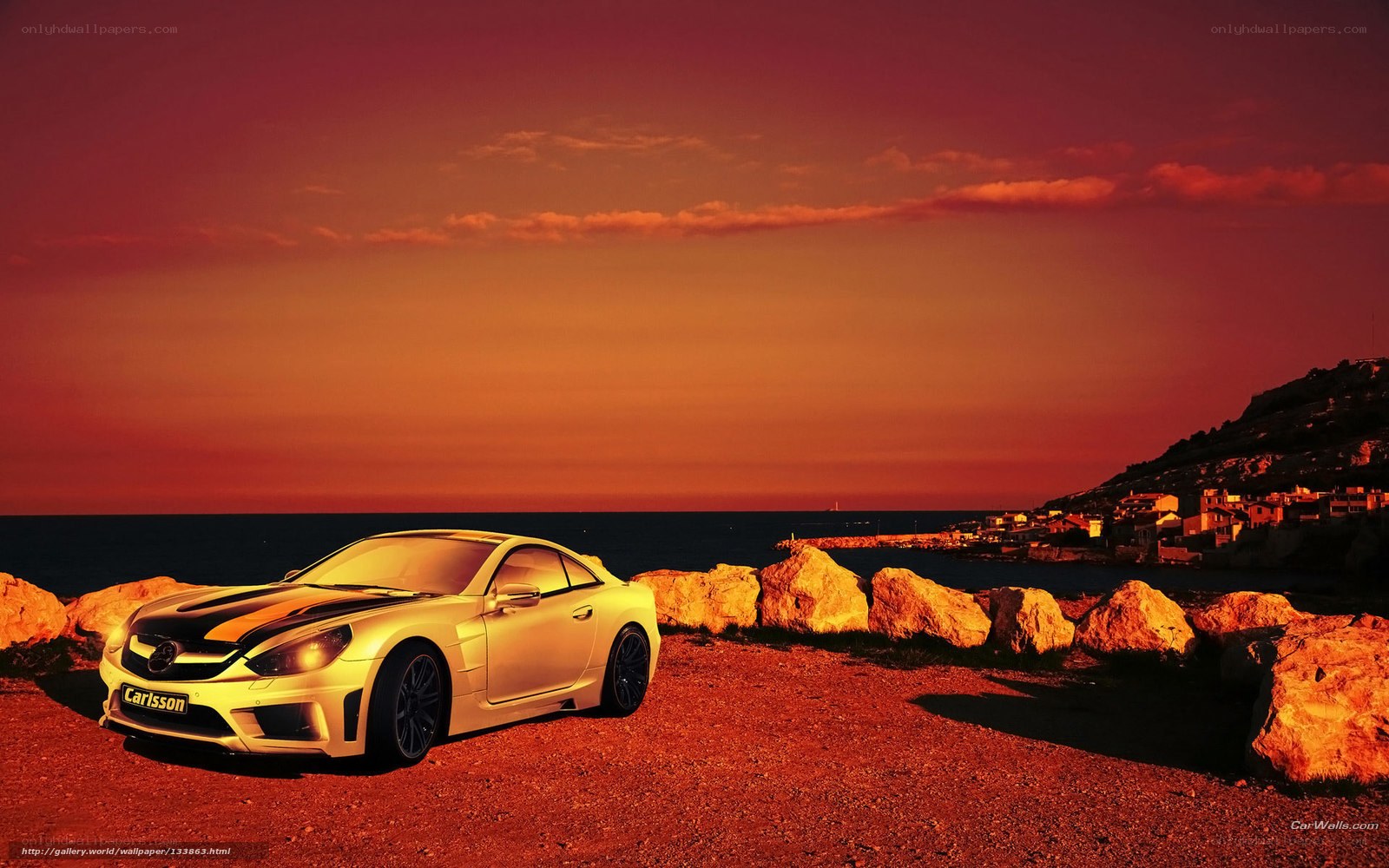 White car at sunset by the sea