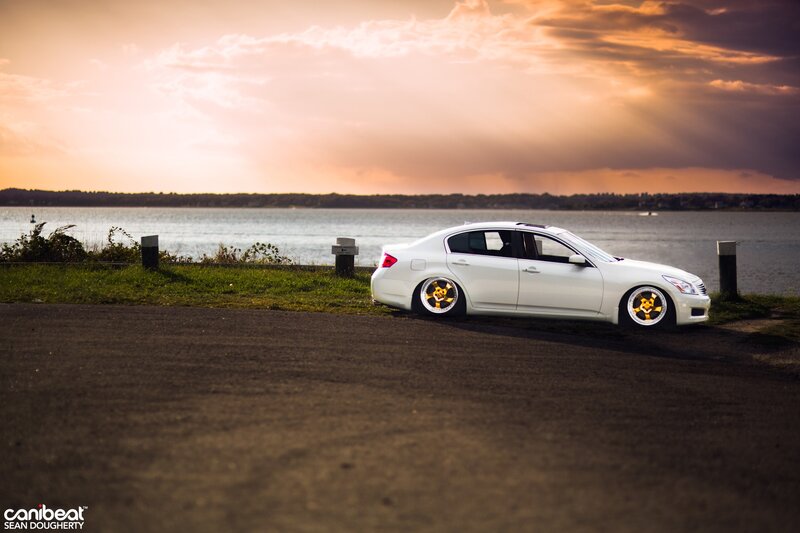 White car at sunset by the water