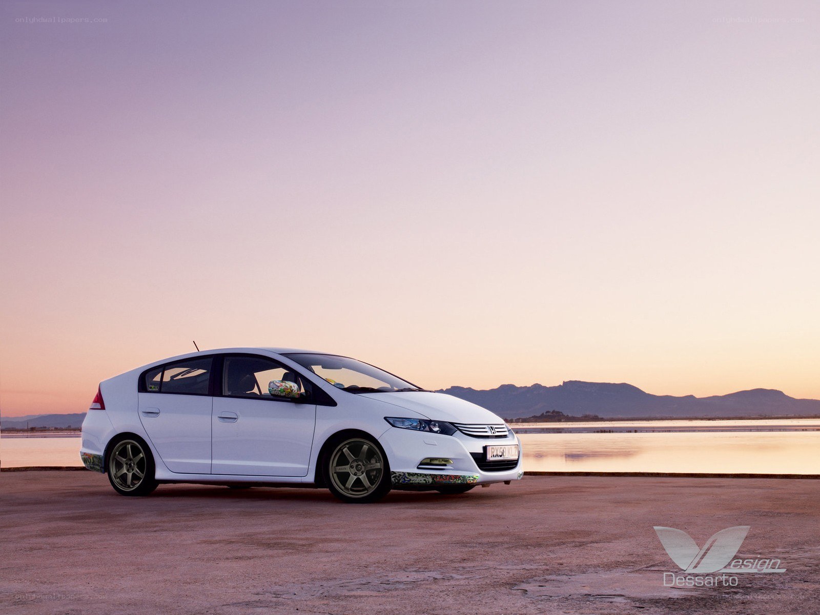 White car at sunset by water
