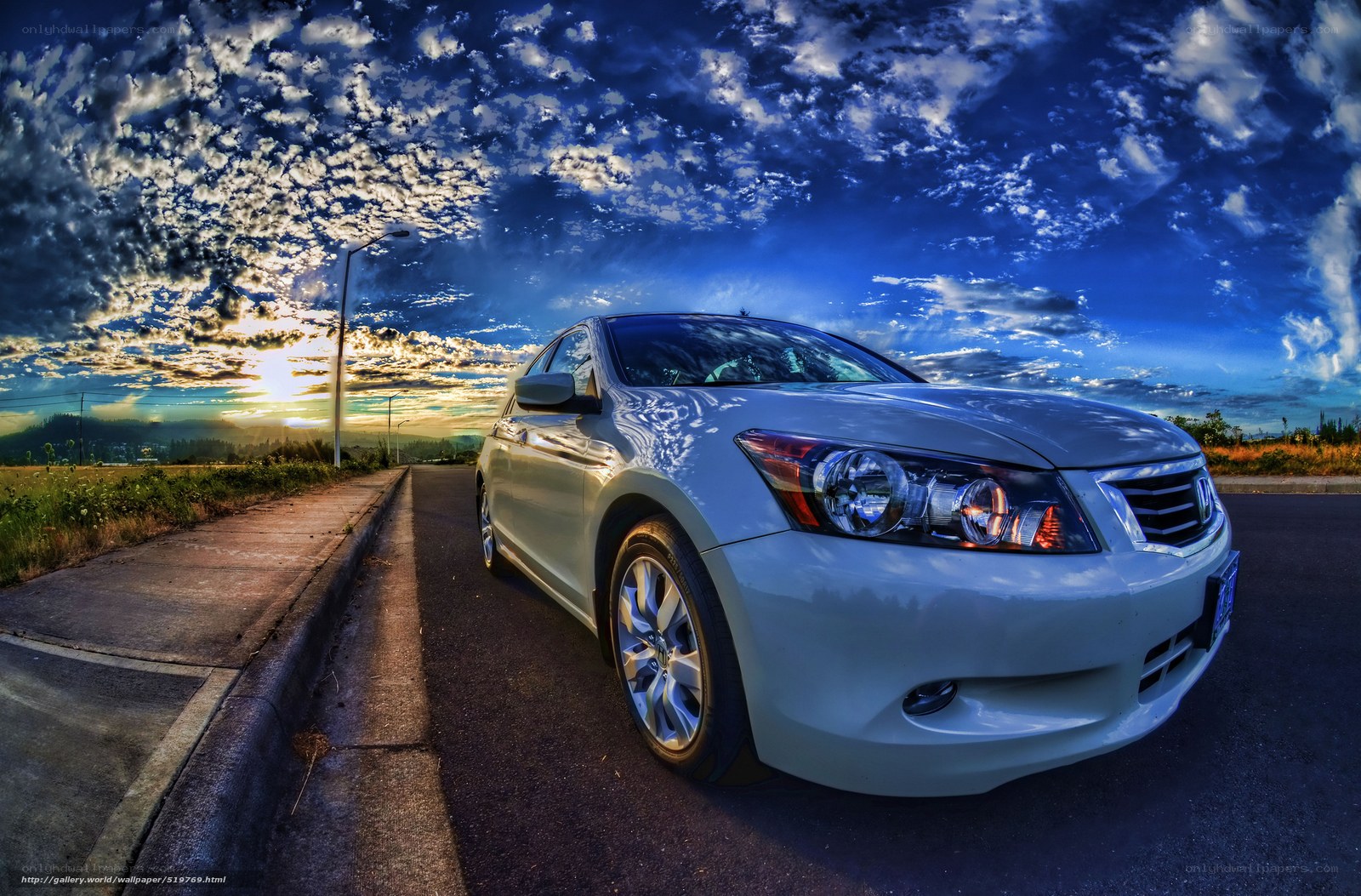 White car at sunset on road
