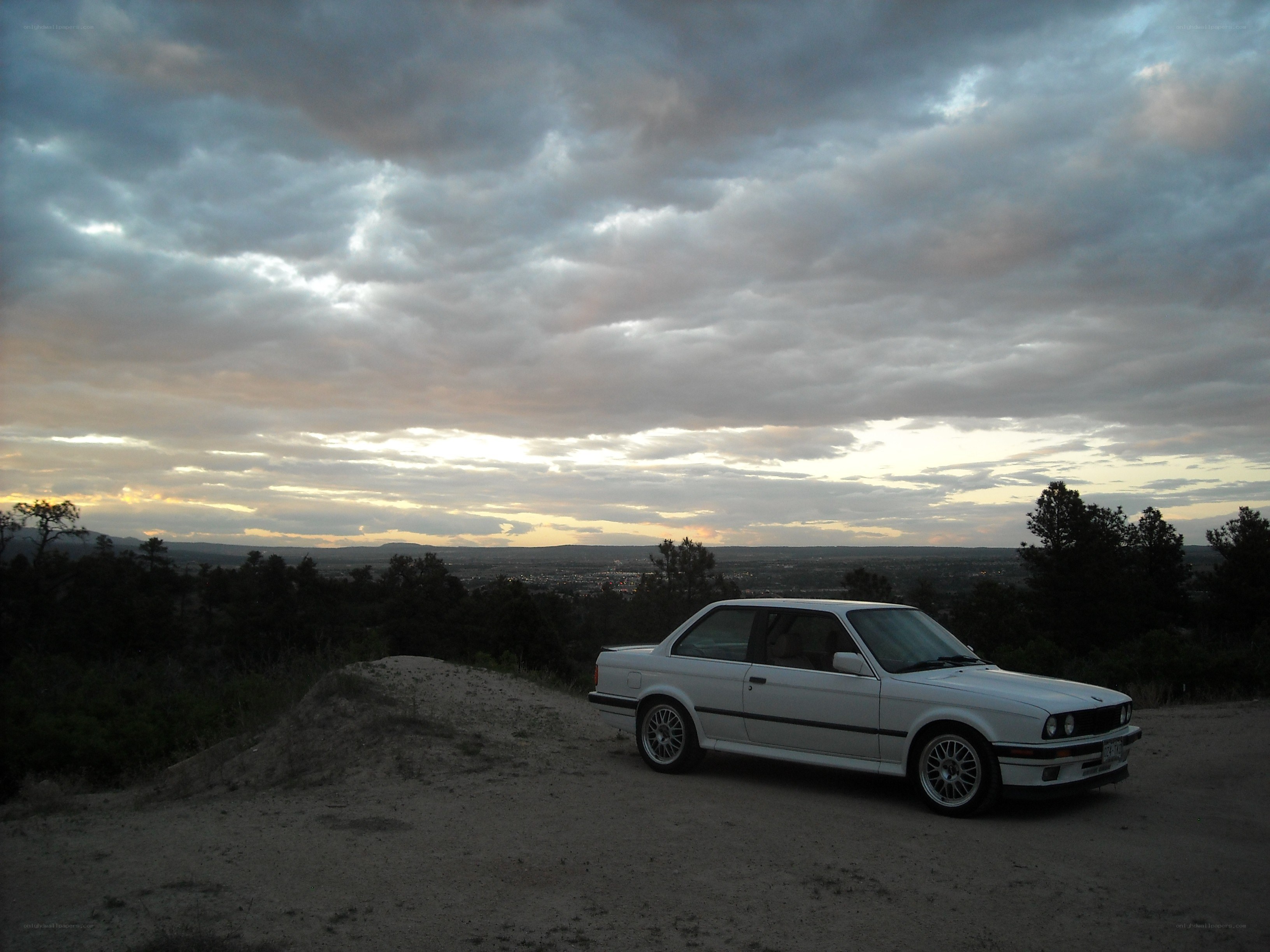 White car at sunset overlook