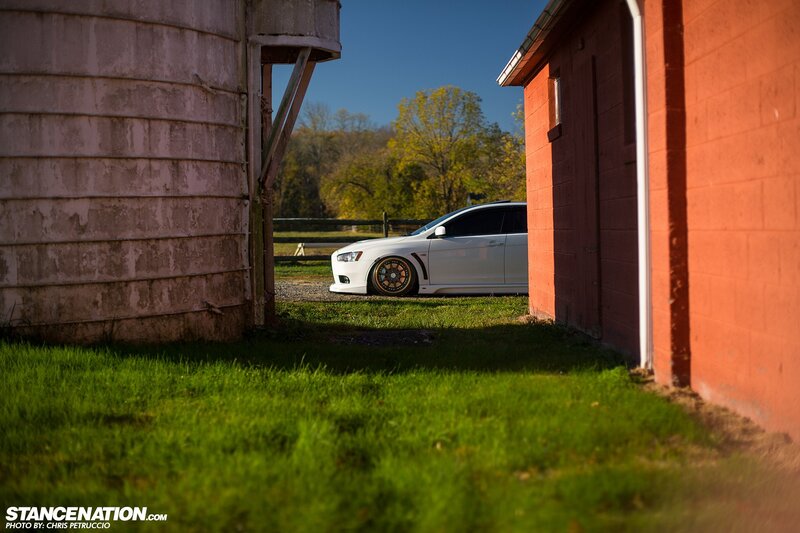 White Car Between Barns