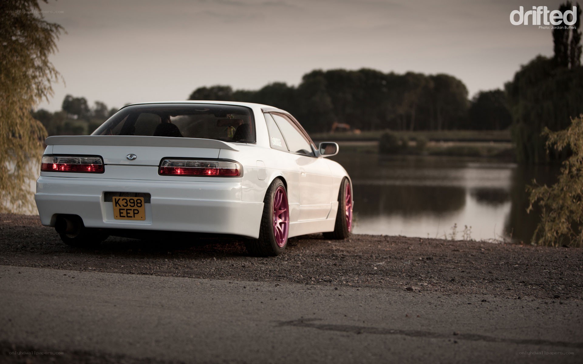 white car by a lake