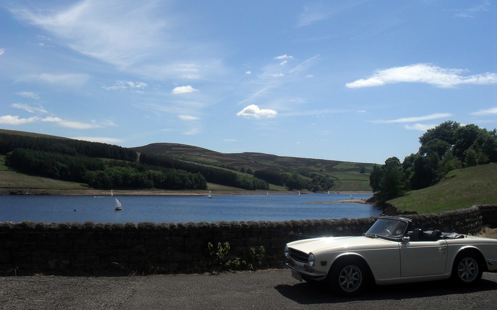 White car by a lake