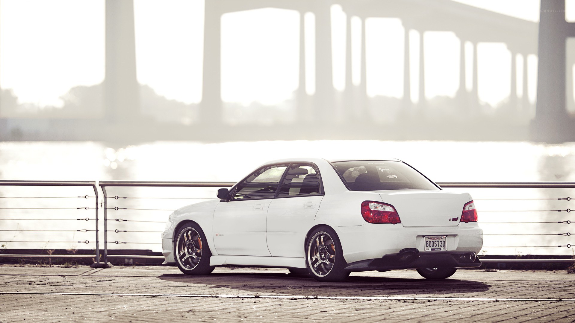 white car by the water