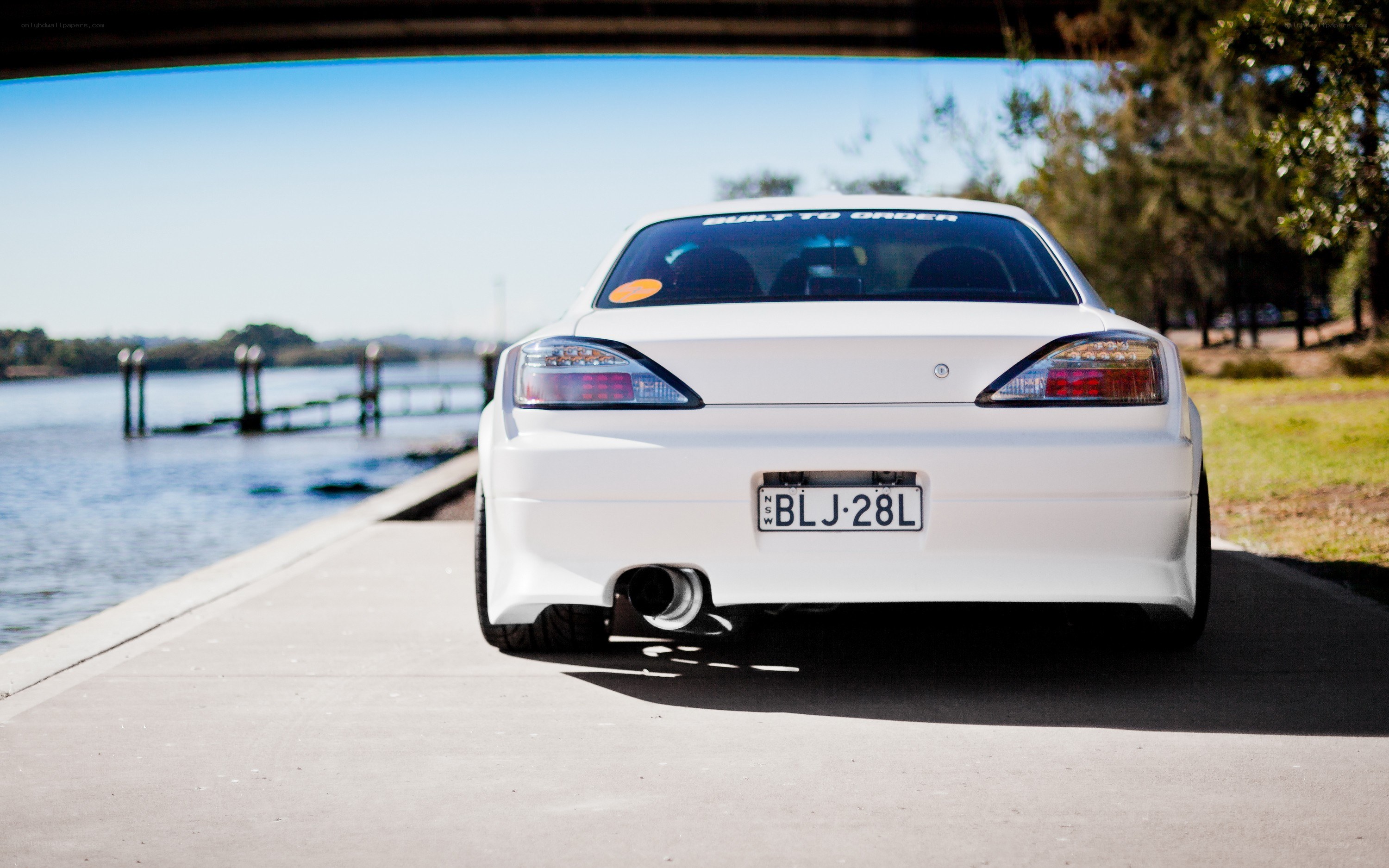 white car by the water