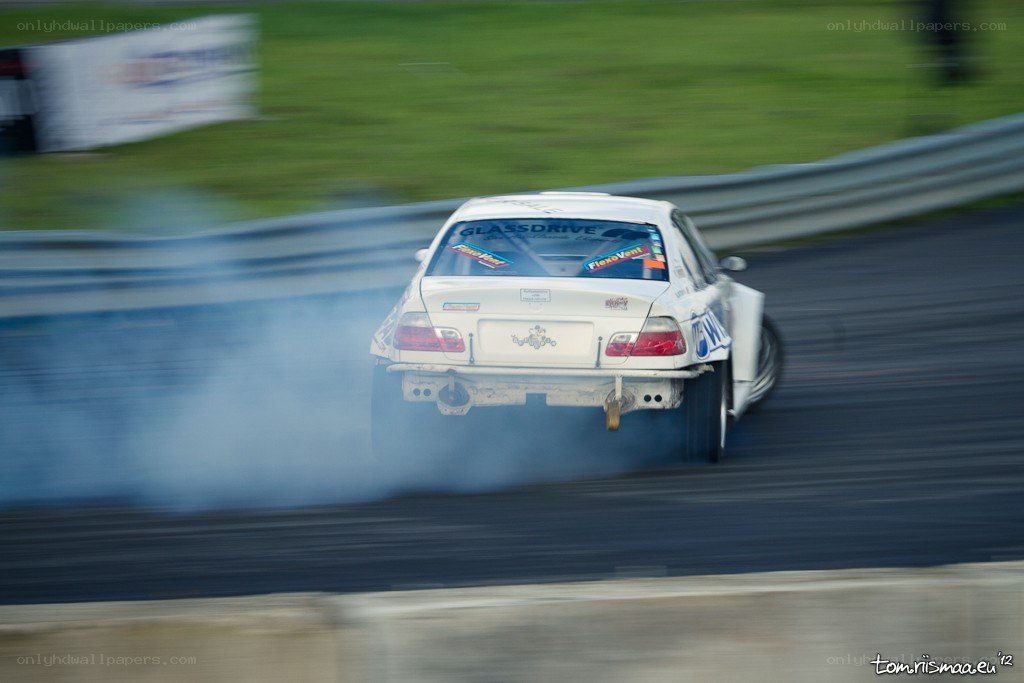white car drifting on track