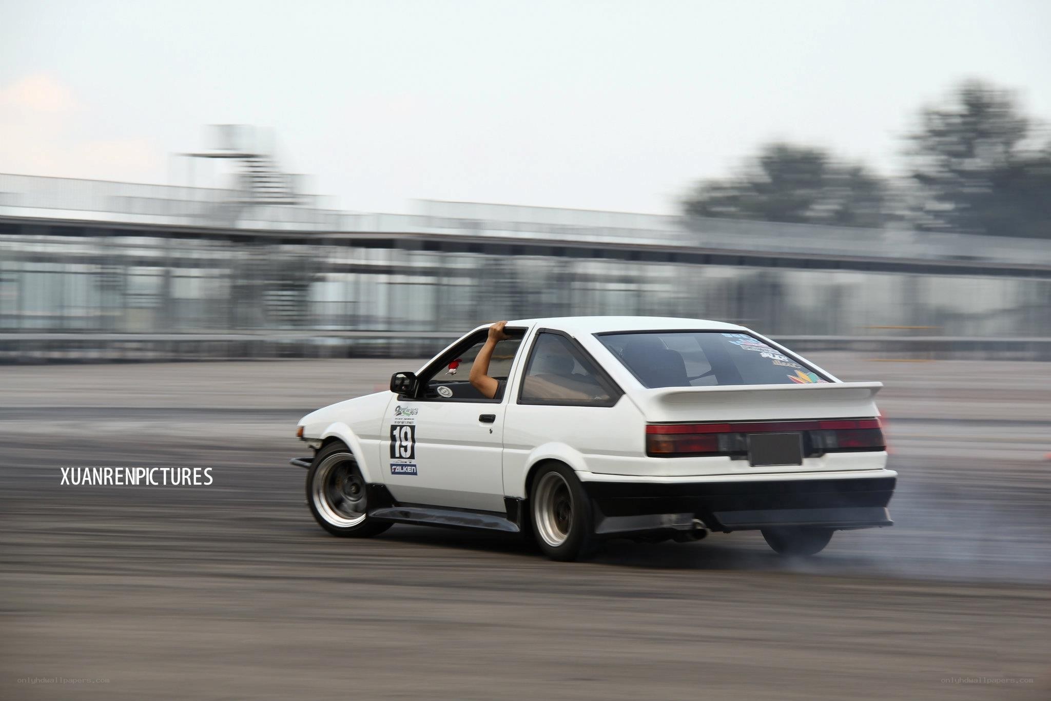 white car drifting on track