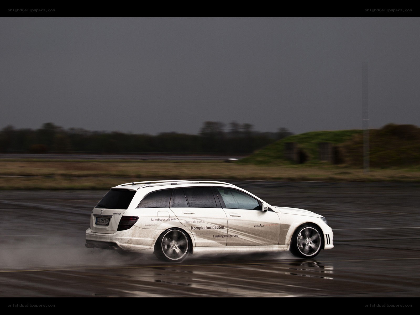 white car drifting on wet track