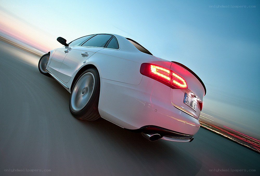 white car driving at dusk