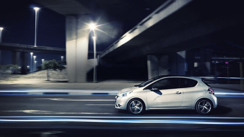 White car driving at night